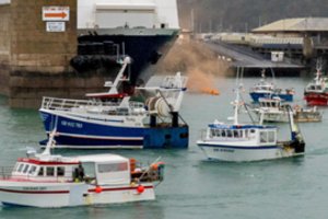 Į protestą susirinkę prancūzų žvejų laivai palieka Džersio vandenis
