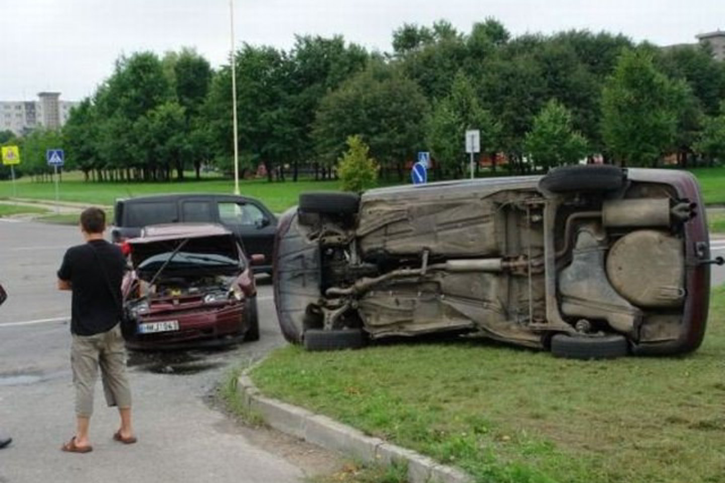 Vienas automobilis apvirto ant šono.
