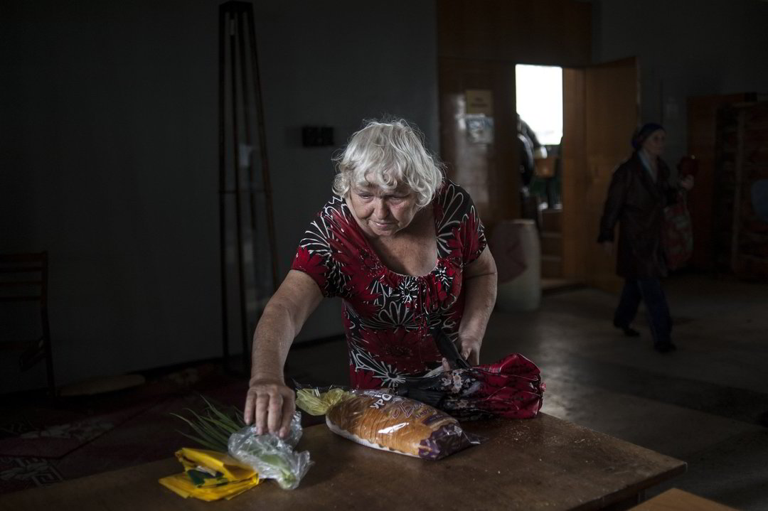 Moteris parsineša namo gautą maisto davinį.<br>AP nuotr.