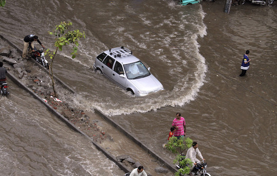Lietaus sukelti potvyniai griovė namus ir pražudė dešimtis žmonių.<br>AP nuotr.