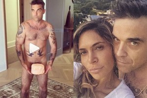 Robbie Williamsas intriguoja: intymią vietą prisidengė tik tortu