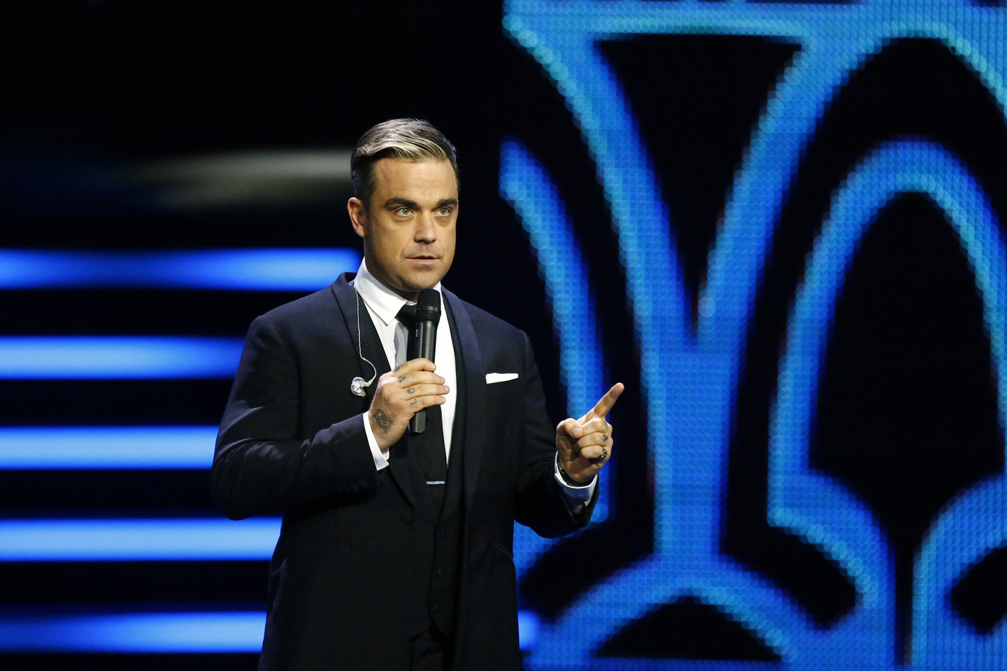 Robbie Williamsas taps trečiuoju atlikėju, kurio nuopelnai muzikai bus įvertinti prestižiniu „BRITs Icon“ apdovanojimu.<br>Scanpix nuotr.