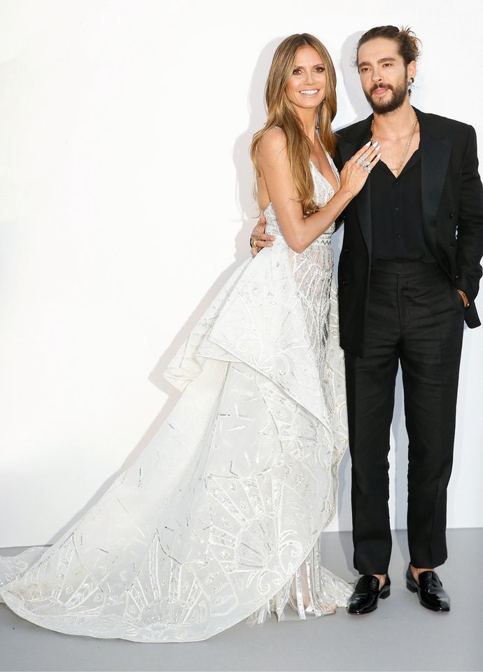 Heidi Klum ir Tomas Kaulitzas oficialia pora tapo kartu pasirodę per Kanuose labdaros tikslais surengtą vakarienę „amfAR“.<br>„Scanpix“ nuotr.