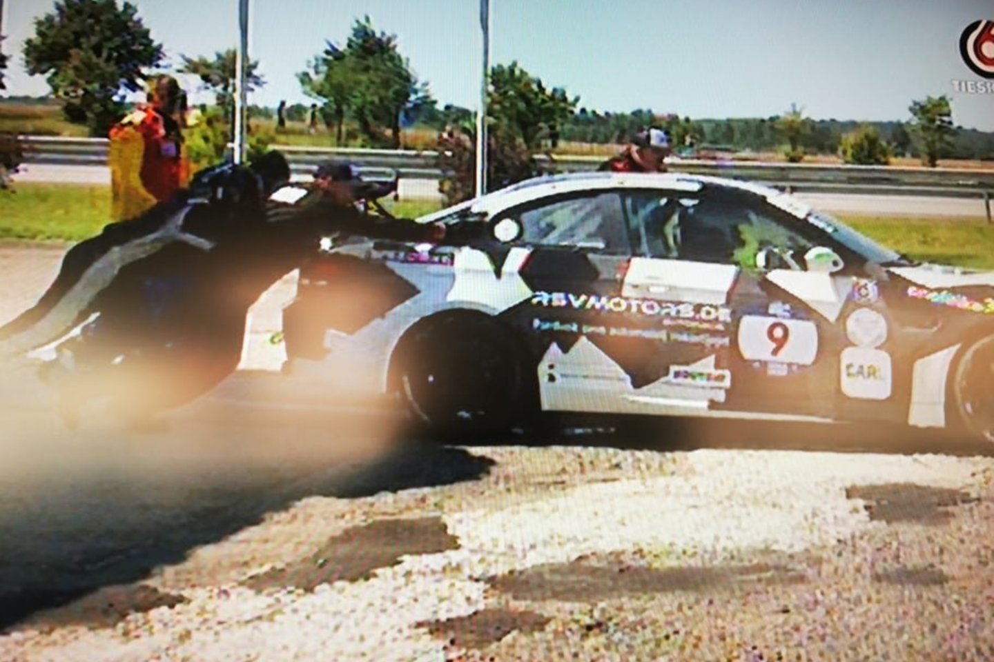  Lenktynėse Palangoje vienas iš automobilių susidūrė su bėdomis degalinėje.<br>Stop kadras iš lenktynių transliacijos 