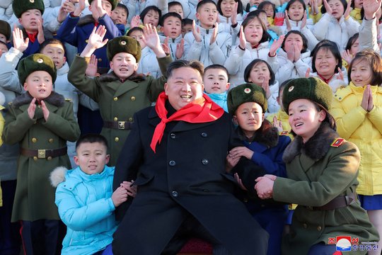 Šiaurės Korėjos lyderis Kim Jong Unas pozuoja grupinei nuotraukai su Korėjos vaikų sąjungos atstovais Pchenjane.