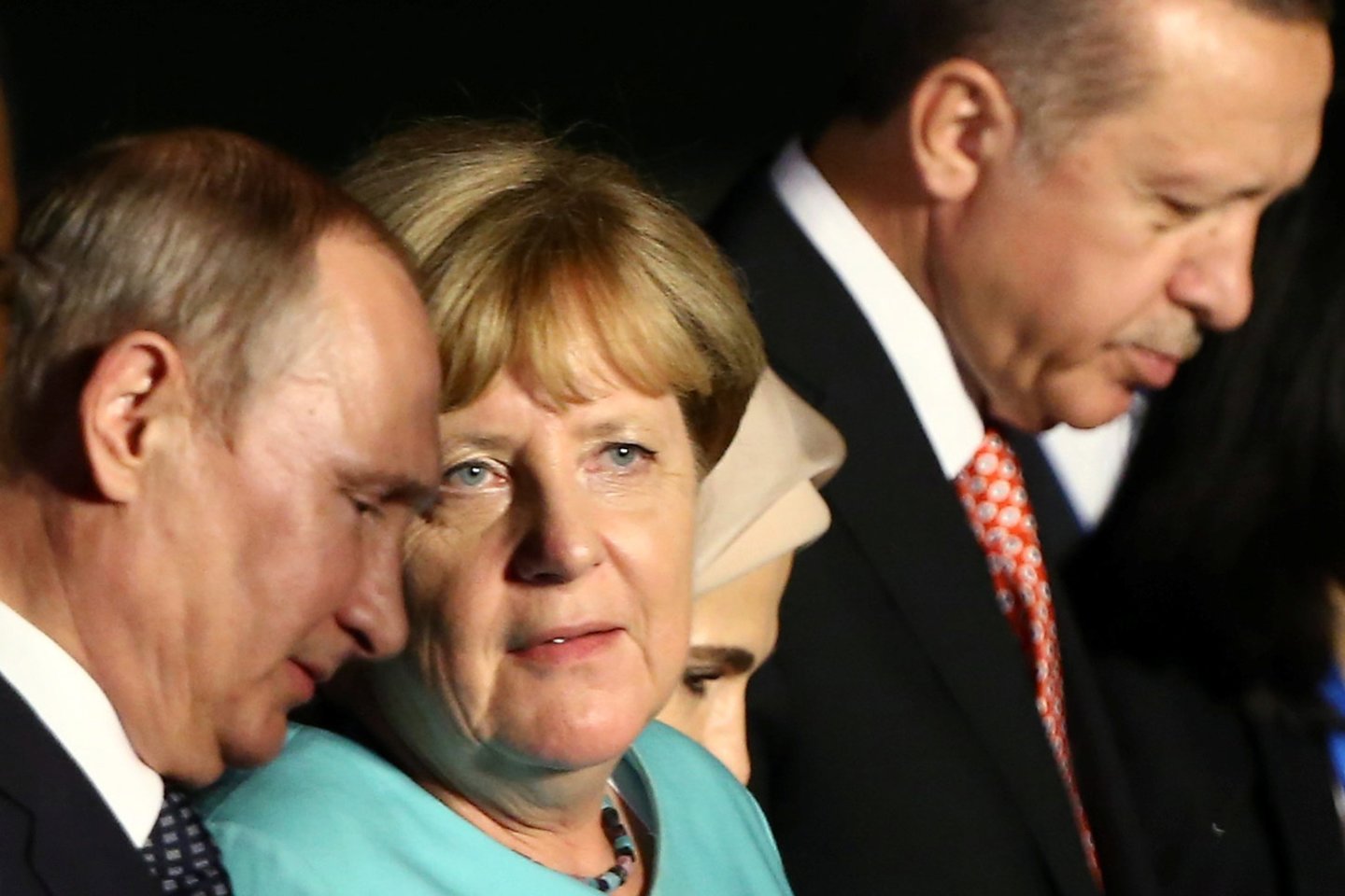  V. Putinas, A. Merkel ir R. T. Erdoganas.<br> Reuters/Scanpix nuotr.
