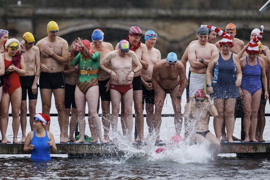 Plaukikai kasmetinėse Kalėdų dienos lenktynėse dėl Piterio Peno taurės, kurios vyksta Serpentino ežere Hyde parke, Londone.<br>EPA-ELTA nuotr.