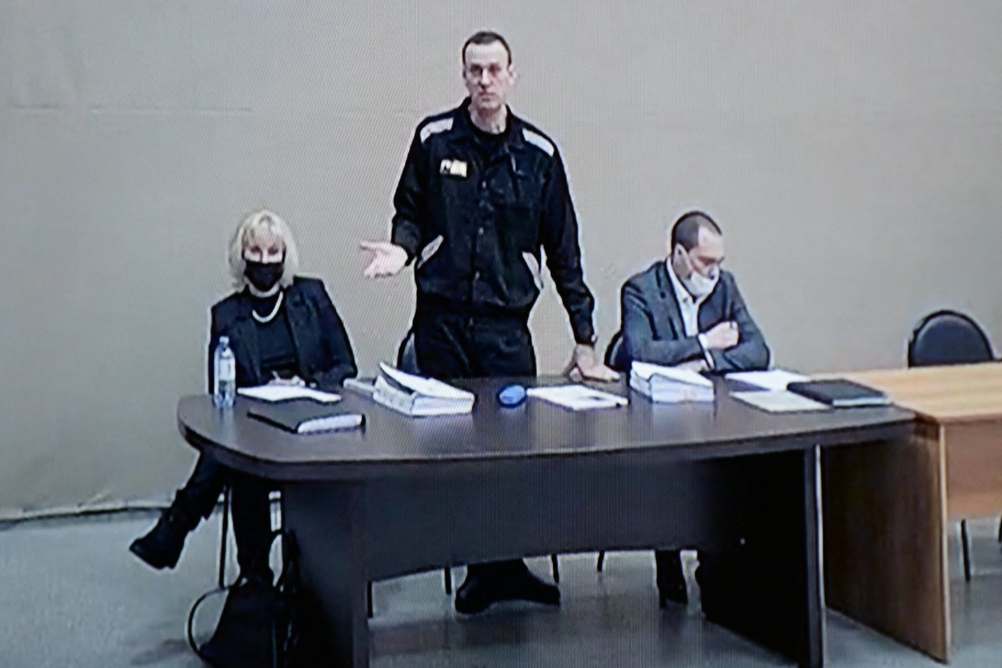 Rusijos opozicijos lyderis Aleksejus Navalnas, advokatai Olga Michailova ir Vadimas Kobzevas matomi ekrane per vaizdo ry<br>Reuters/Scanpix nuotr.