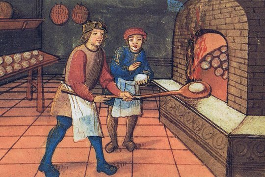  Kepėjas su padėjėju, kepantys duonos kepaliukus arba bandeles. Iš maždaug 1500 m. rankraščio „Book of hours“.