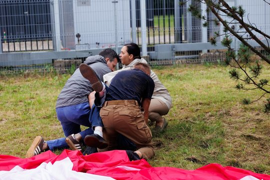Išpuolis per JAV minėjimą Vilniuje: jaunuolis užšoko ant milžiniškos vėliavos ir ją trypė
