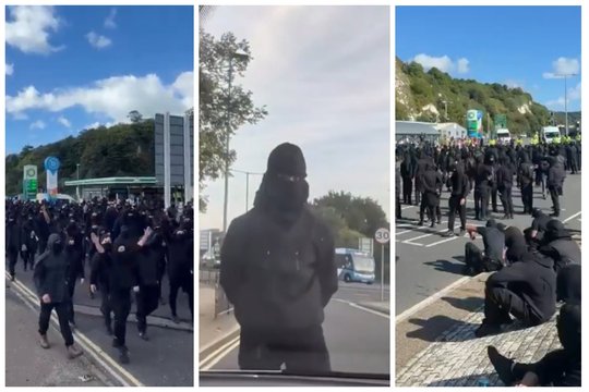 Jungtinėje Karalystėje – juodai apsirengusių kaukėtų protestuotojų blokada: plinta įrašai